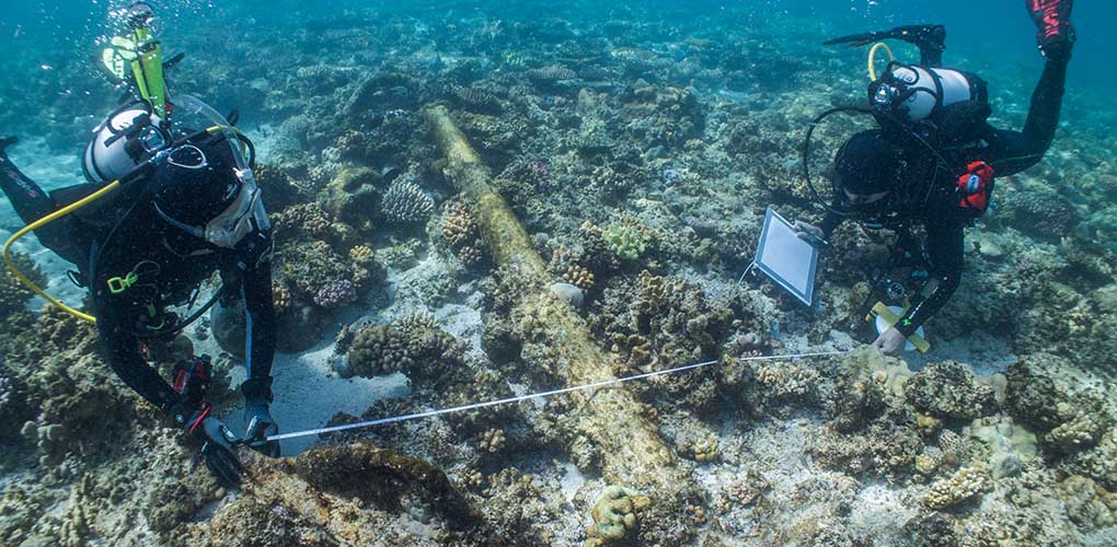 The author (right) and Irini Malliaros from the Silentworld Foundation use ‘old school’ methods to obtain measurements of the Admiralty Old Pattern Long-Shanked Anchor found in the shallows at Boot Reef. Image: Julia Sumerling/Silentworld Foundation. 