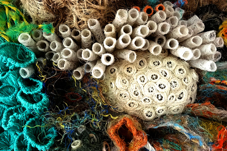 Artist Marion Gaemers creation of colourful corals, with pops of orange and yellow among the calm blues and greens. Image: Erub Arts. 