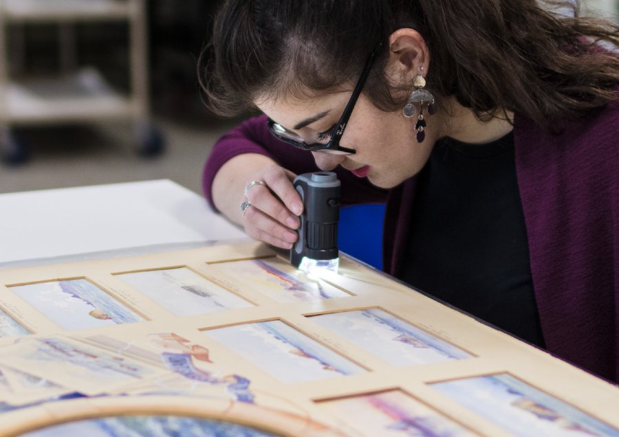 Using a hand held microscope with an LED light that allows you to look closely at an item, up to 120 x magnification! You can see the paper fibres and incredible detail of the materials and condition