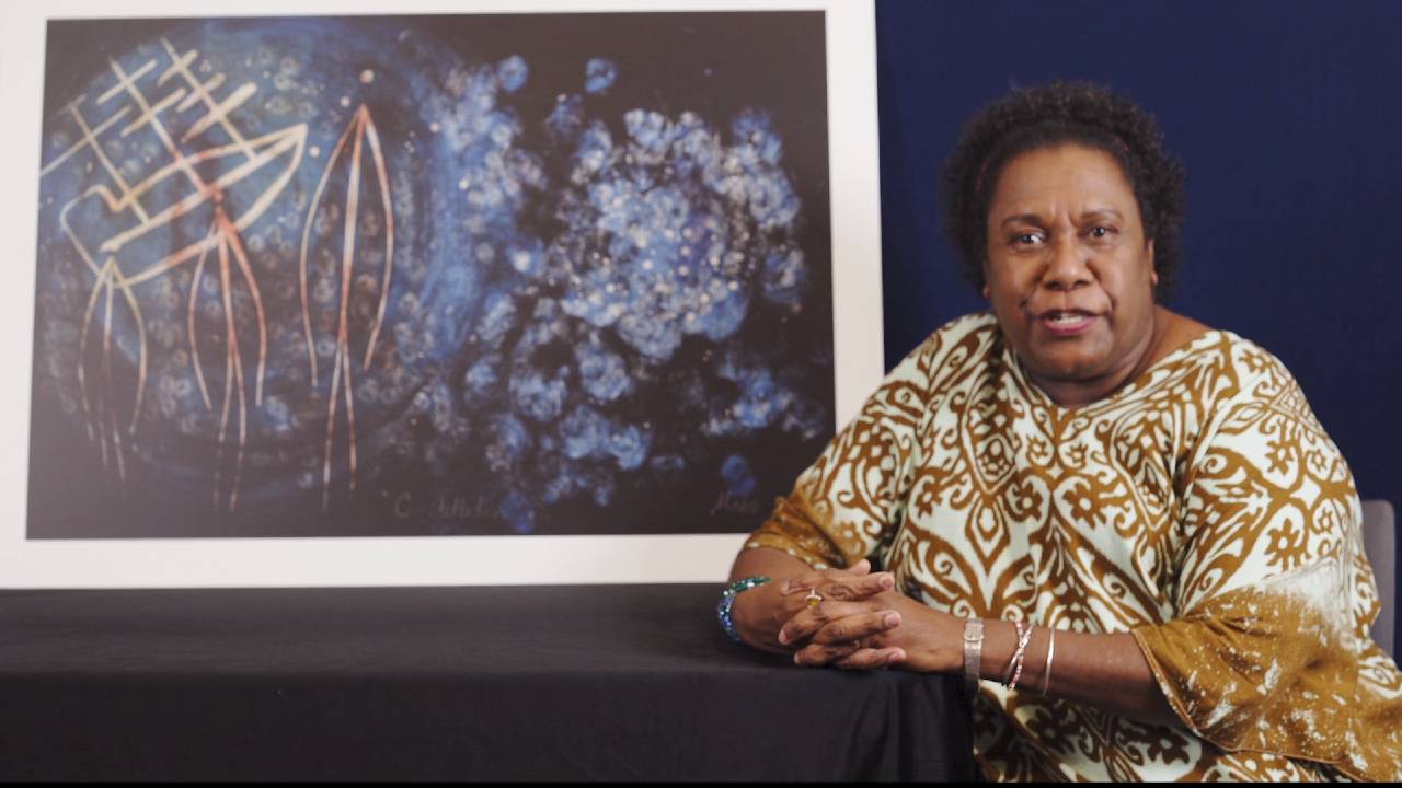 Gail Mabo with her artwork Constellations in the background