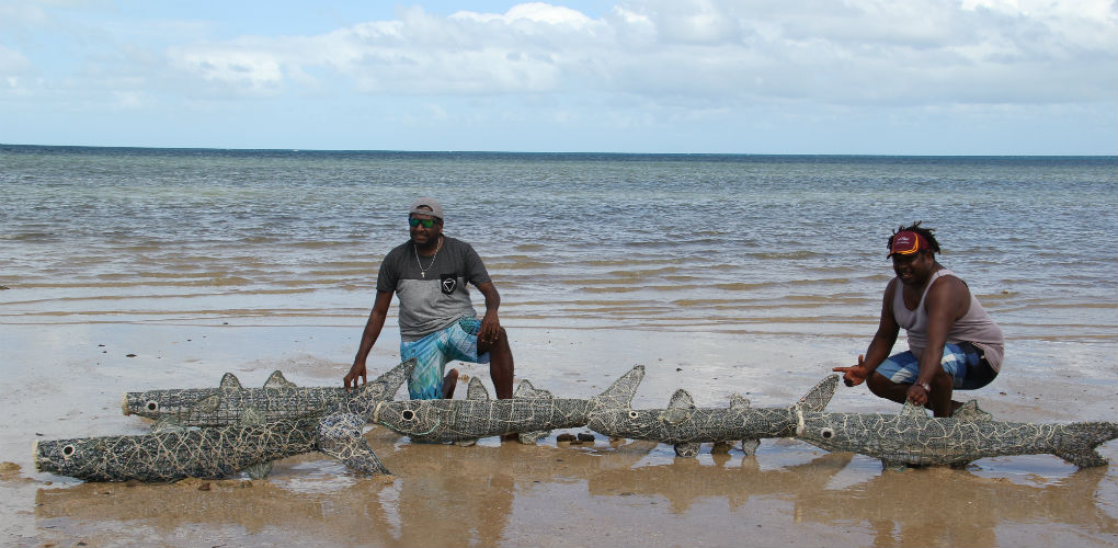 Artists Jimmy J Thaiday and Jimmy K with their ghost net mullet. Photography by Lynnette Griffiths.