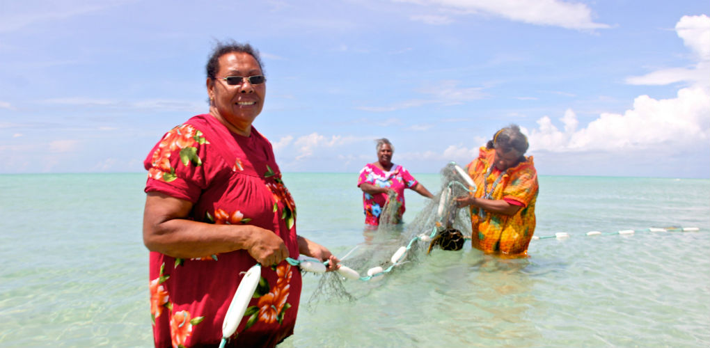 Artists with ghost net sculptures. Photo: Erub Arts, Darnley Island, Torres Strait