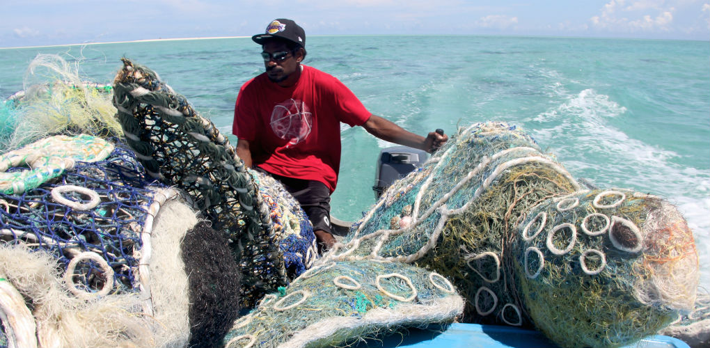 With ghost net sculptures. Photo: Erub Arts, Darnley Island, Torres Strait